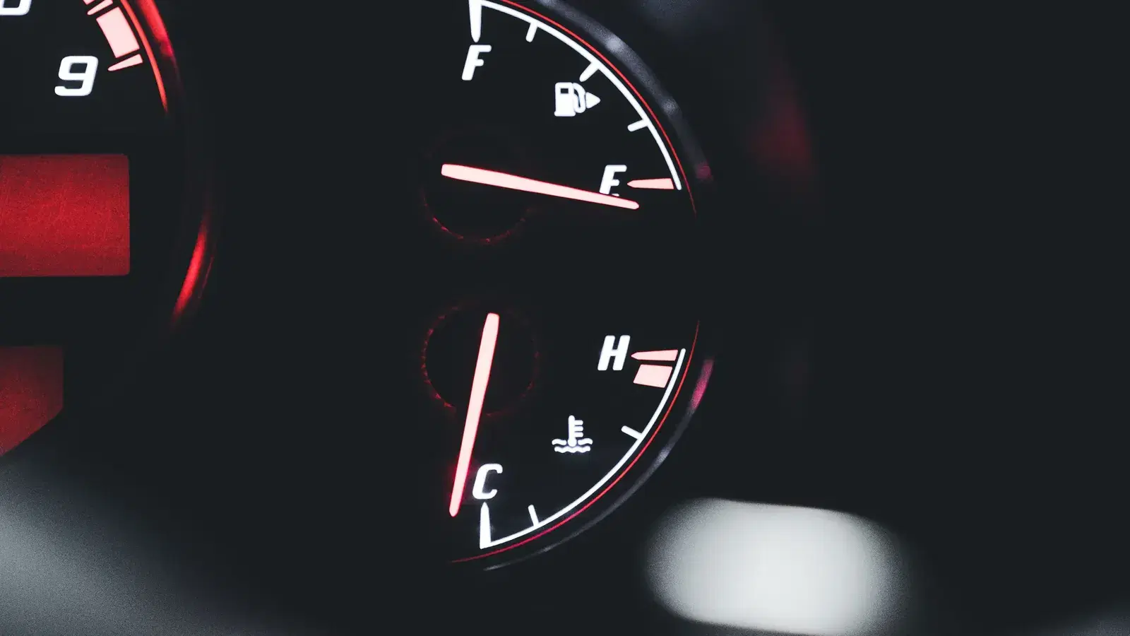 Backlit instrument cluster with the coolant temperature needle sitting low towards C