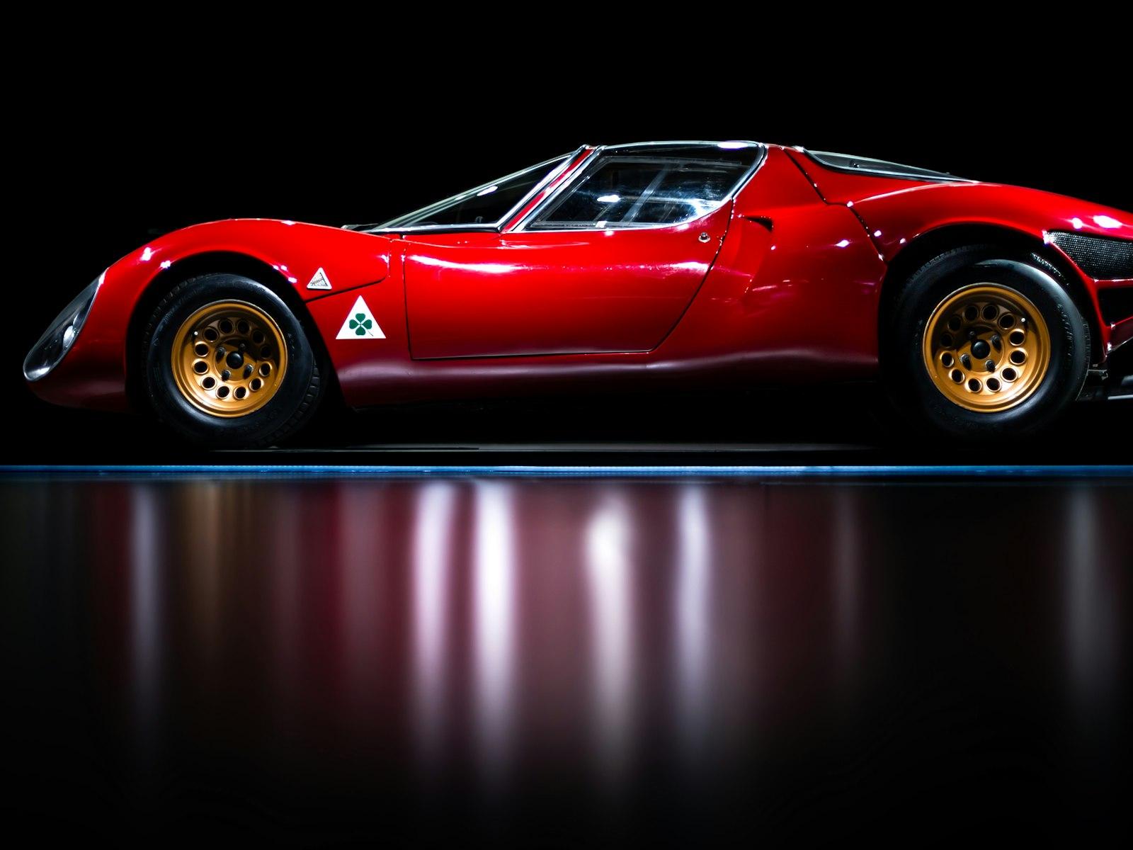 Red Alfa Romeo 33 Stradale in profile, cloverleaf badge on the front wing