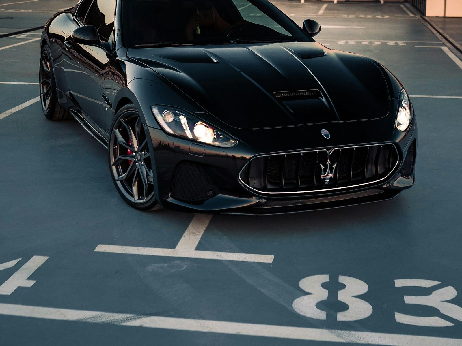 Black Maserati GranTurismo front end with the trident badge in the grille