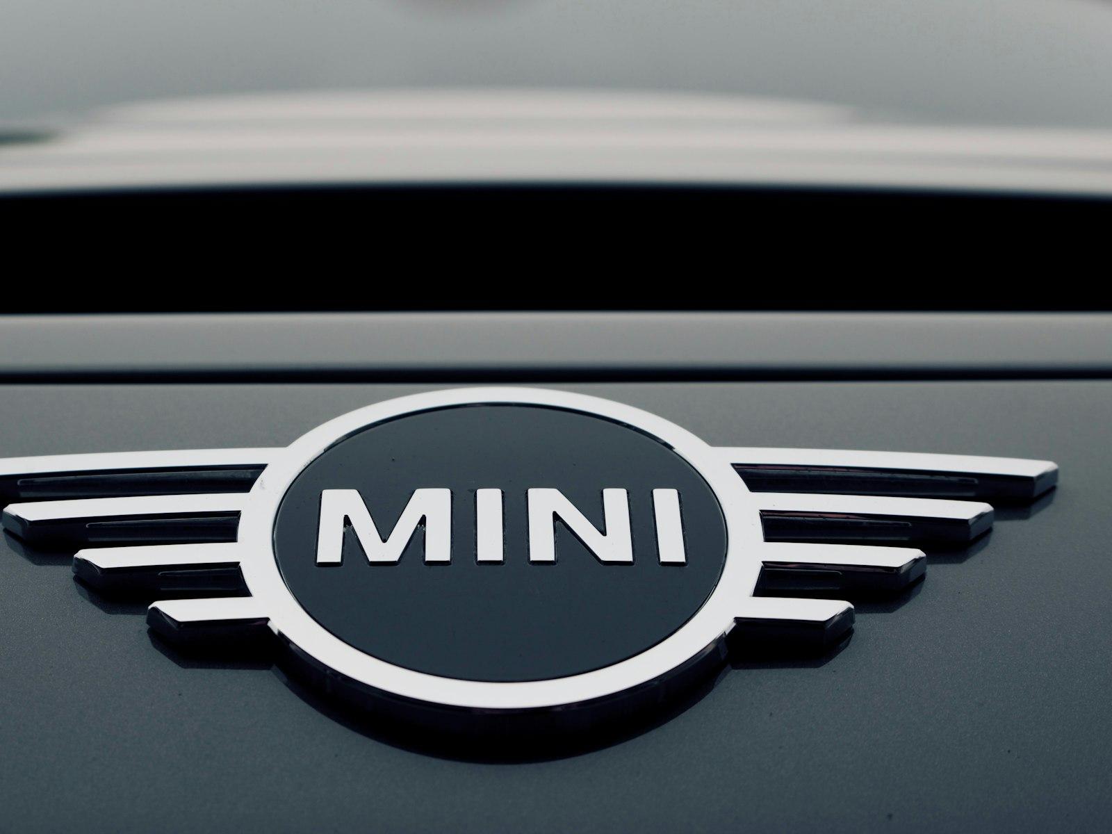 Close-up of the winged Mini badge on the bonnet of a grey Cooper