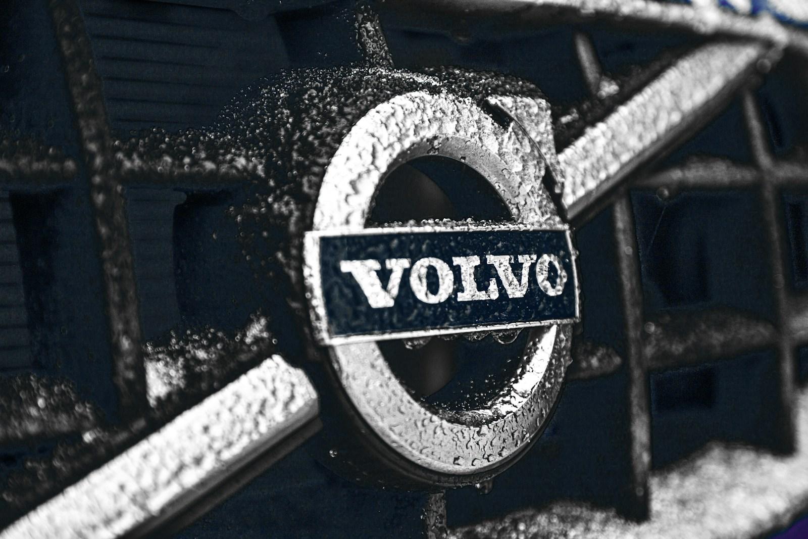 Close-up of the Volvo iron mark badge on a wet grille