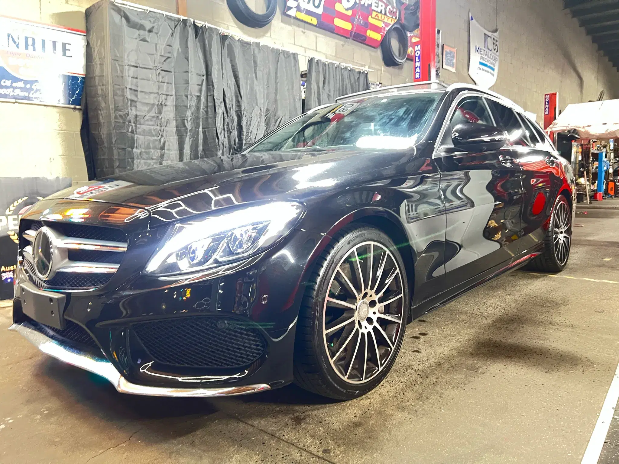Freshly detailed black Mercedes-Benz wagon with AMG-style alloy wheels