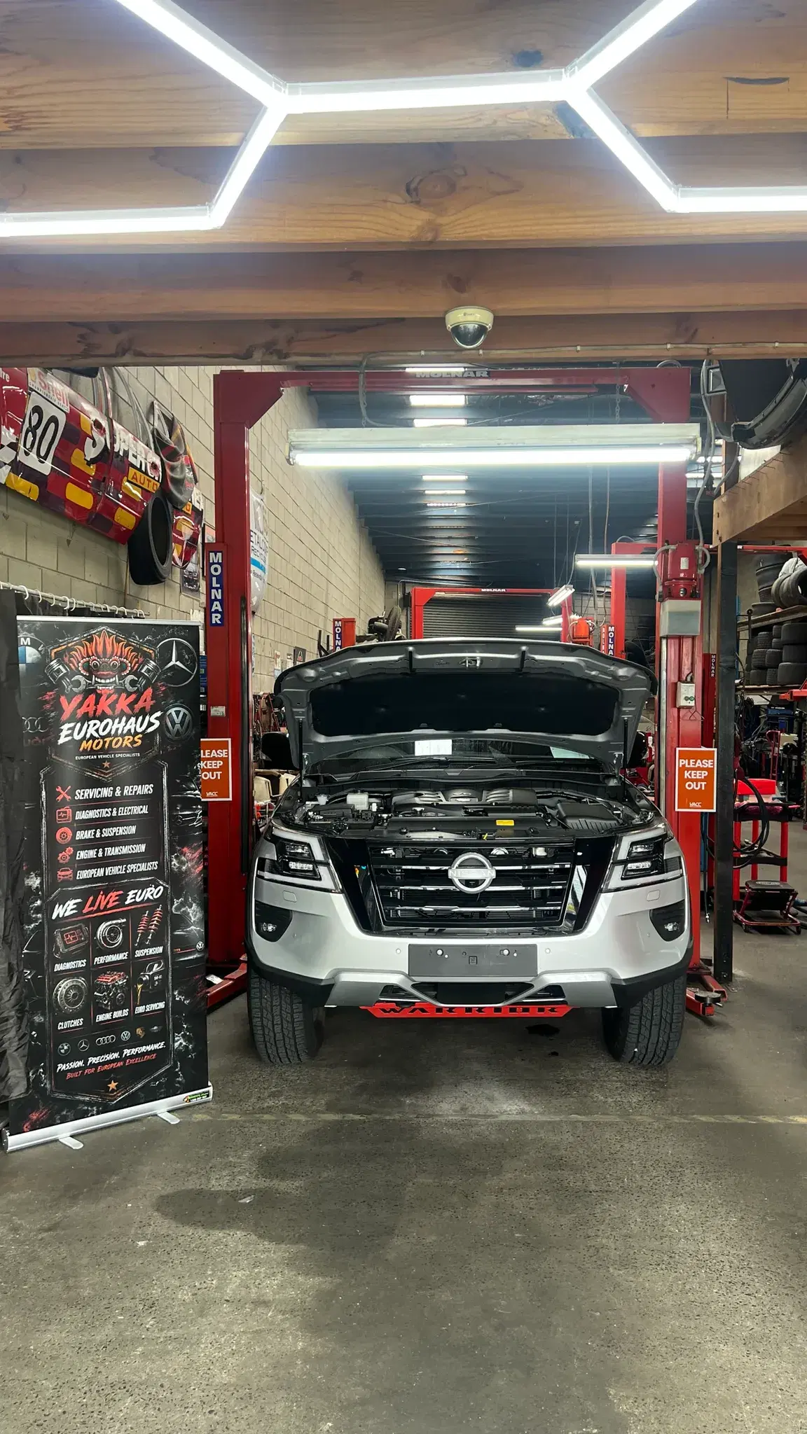 Nissan Navara Warrior with the bonnet up in the workshop bay